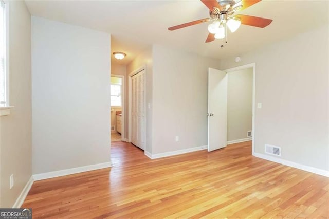 empty room featuring ceiling fan and light hardwood / wood-style floors