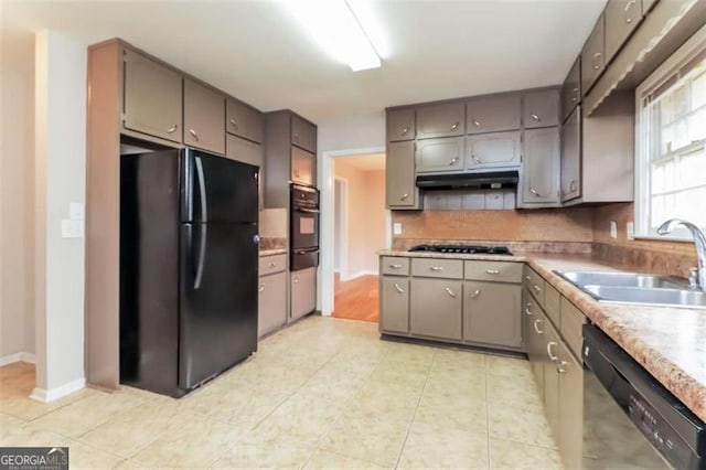 kitchen with gray cabinets, sink, tasteful backsplash, and black appliances