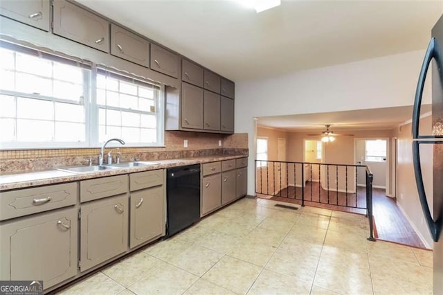 kitchen featuring ceiling fan, decorative backsplash, sink, light tile patterned flooring, and black dishwasher