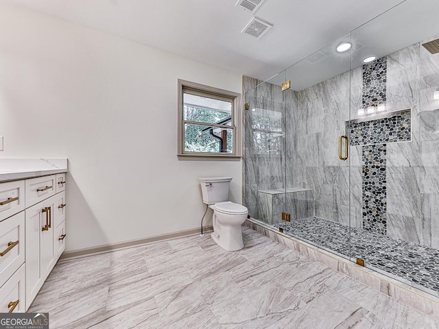 bathroom featuring vanity, a shower with shower door, and toilet