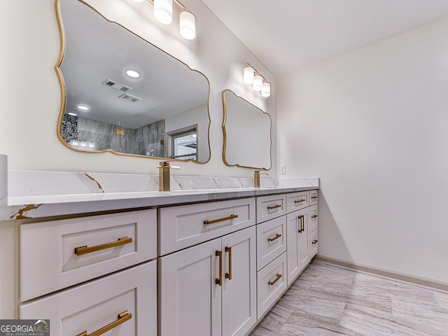 bathroom featuring a shower and vanity