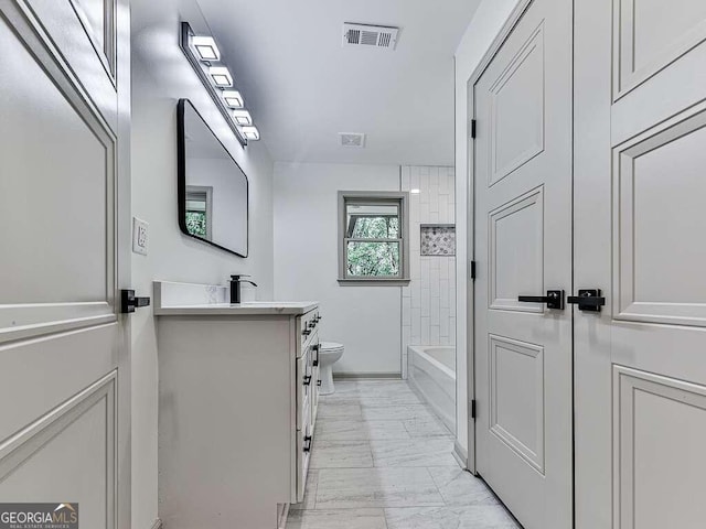 full bathroom with vanity, toilet, and tiled shower / bath