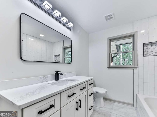 bathroom featuring vanity and toilet