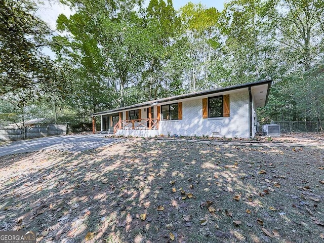 ranch-style house featuring cooling unit