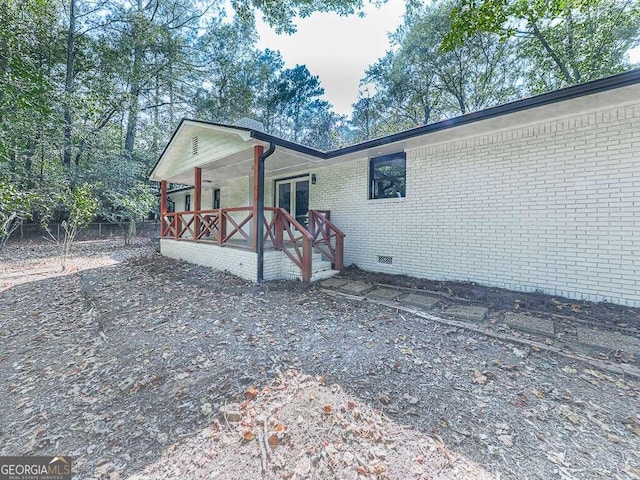 view of property exterior with a porch