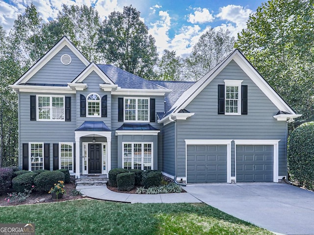 view of front property featuring a front yard and a garage