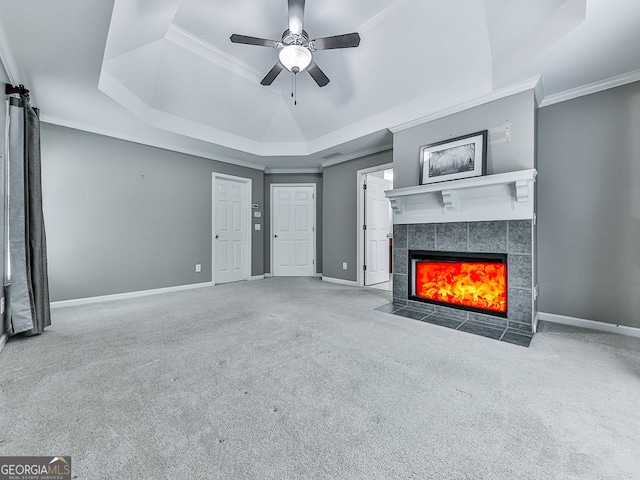 unfurnished living room featuring carpet flooring, ceiling fan, a raised ceiling, and a fireplace