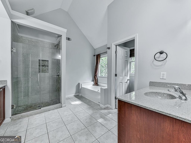 bathroom with tile patterned flooring, lofted ceiling, vanity, and independent shower and bath