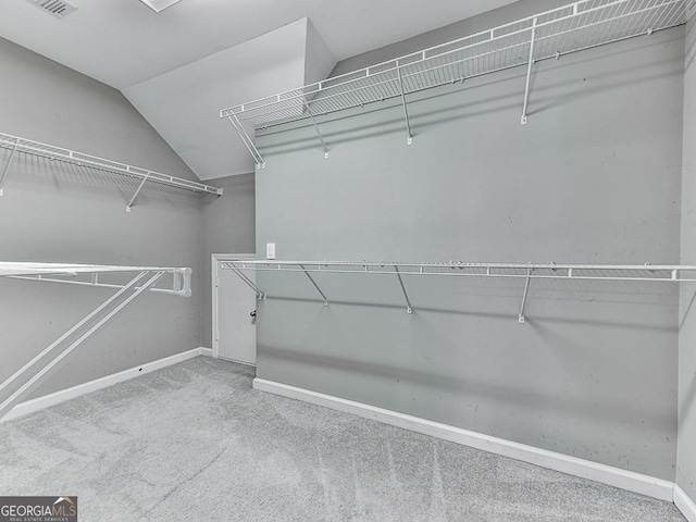 walk in closet featuring carpet flooring and lofted ceiling