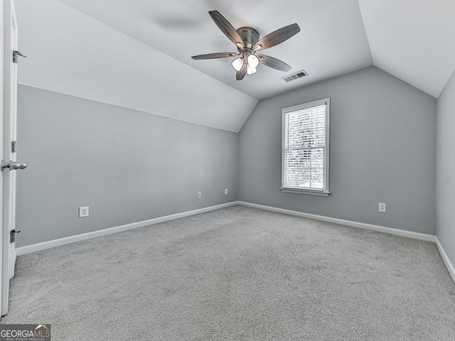 bonus room with ceiling fan, light carpet, and vaulted ceiling