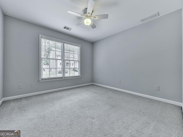 spare room featuring ceiling fan and carpet floors