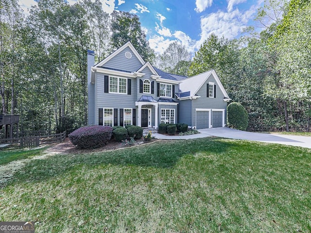 view of front of property featuring a front yard and a garage