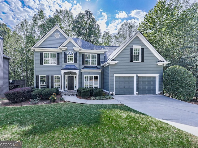 front facade featuring a garage and a front yard