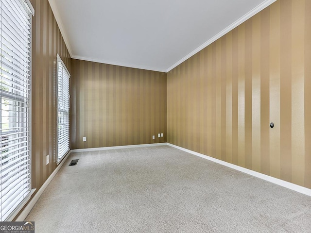 unfurnished room featuring carpet and crown molding