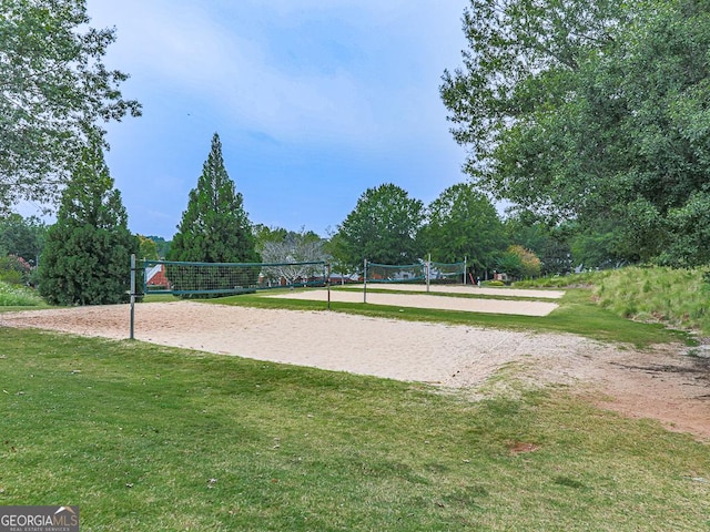 view of home's community with volleyball court and a lawn