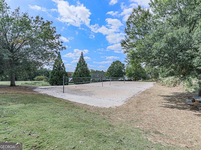 view of property's community featuring volleyball court and a lawn