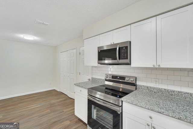 kitchen with white cabinets, appliances with stainless steel finishes, and a textured ceiling