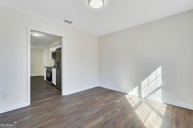 unfurnished room featuring dark hardwood / wood-style floors