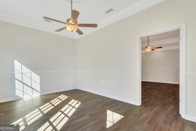 spare room featuring dark hardwood / wood-style floors, ceiling fan, and crown molding