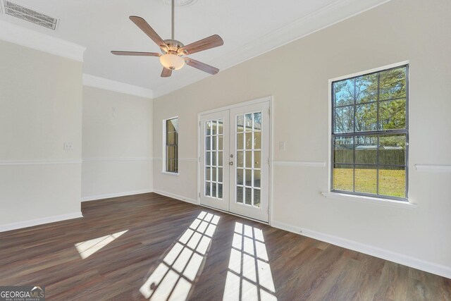 unfurnished room with ceiling fan, dark hardwood / wood-style flooring, crown molding, and french doors