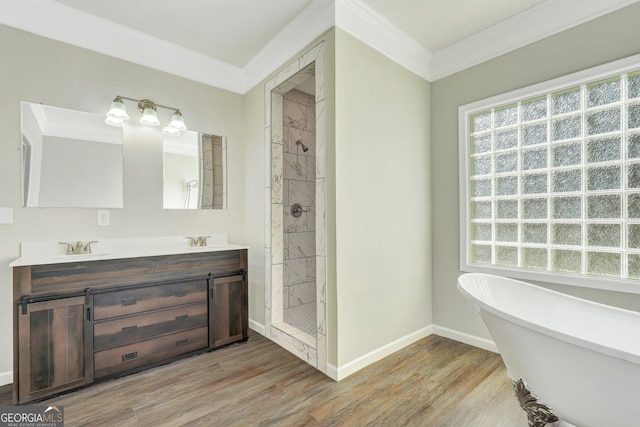 bathroom featuring hardwood / wood-style flooring, vanity, crown molding, and shower with separate bathtub