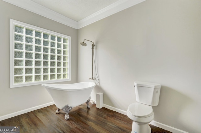 bathroom featuring toilet, hardwood / wood-style floors, a bath, and ornamental molding