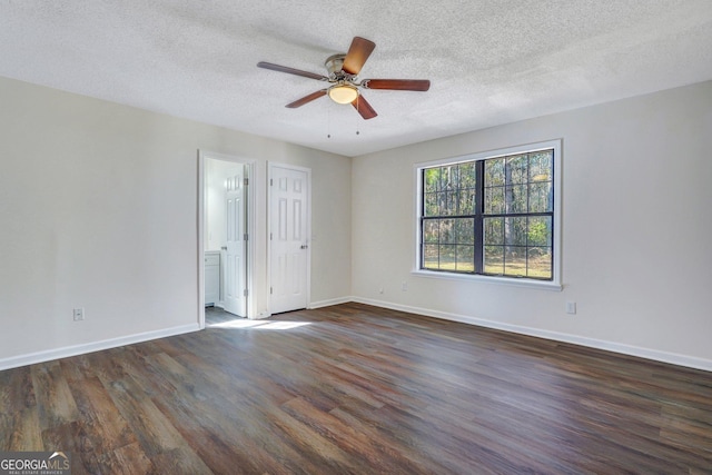 empty room featuring ceiling fan, dark hardwood / wood-style flooring, and a textured ceiling