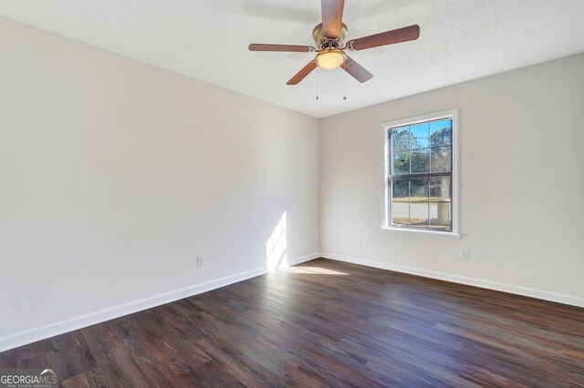 unfurnished room featuring a textured ceiling, ceiling fan, and dark wood-type flooring