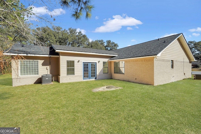 back of house with a yard and central AC unit