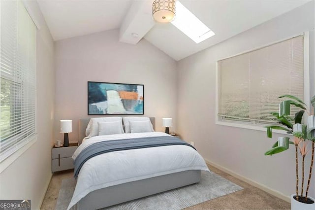 bedroom with light colored carpet and lofted ceiling with skylight