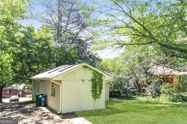 view of outbuilding with a lawn