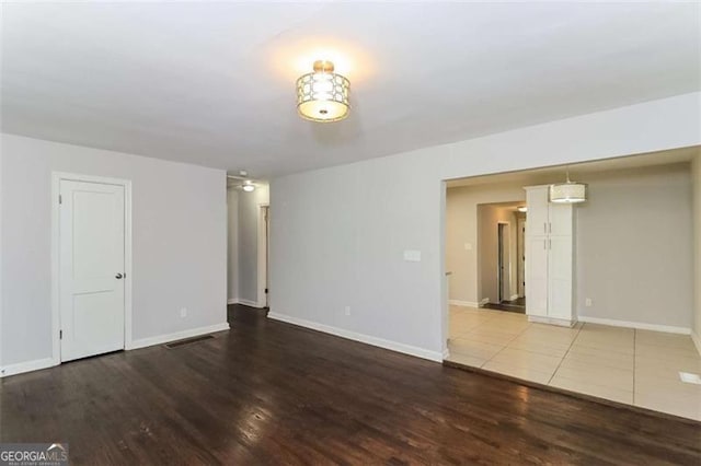 unfurnished room with wood-type flooring