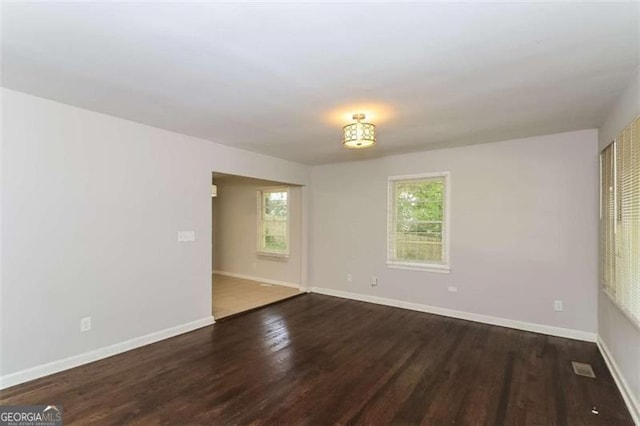 empty room with dark wood-type flooring