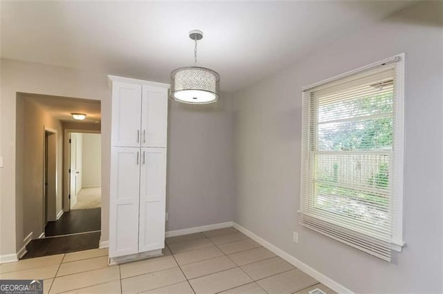 unfurnished dining area with light tile patterned floors