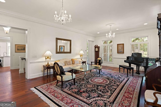 living room featuring crown molding, dark hardwood / wood-style flooring, an inviting chandelier, and sink