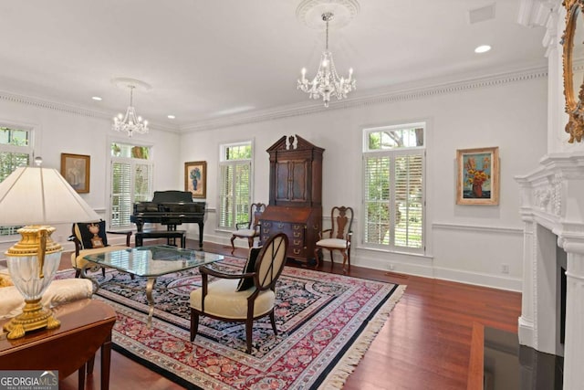 living room with dark hardwood / wood-style floors, an inviting chandelier, and ornamental molding