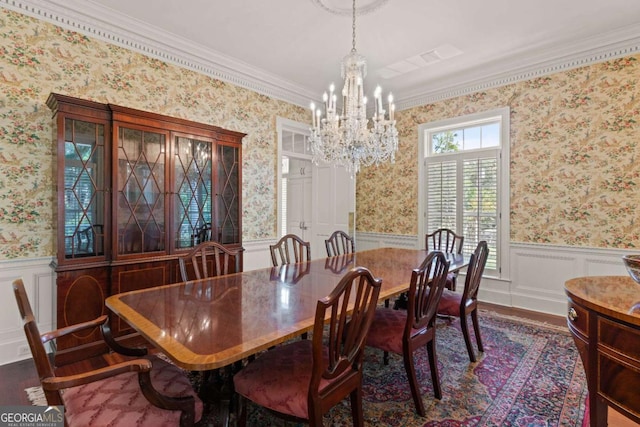 dining room featuring dark hardwood / wood-style floors, an inviting chandelier, and crown molding