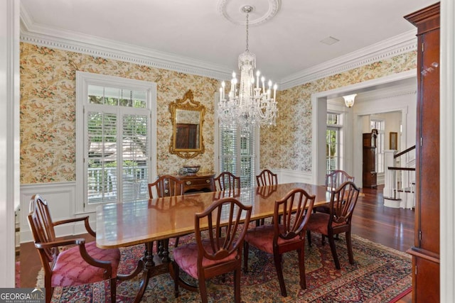 dining space featuring a notable chandelier, dark hardwood / wood-style flooring, and crown molding