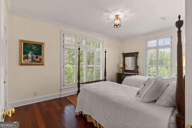 bedroom with crown molding and dark hardwood / wood-style flooring