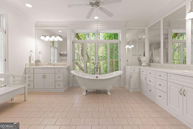 bathroom with ceiling fan, tile patterned floors, a tub to relax in, crown molding, and vanity