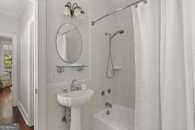 bathroom featuring wood-type flooring, crown molding, tile walls, and shower / bath combo with shower curtain