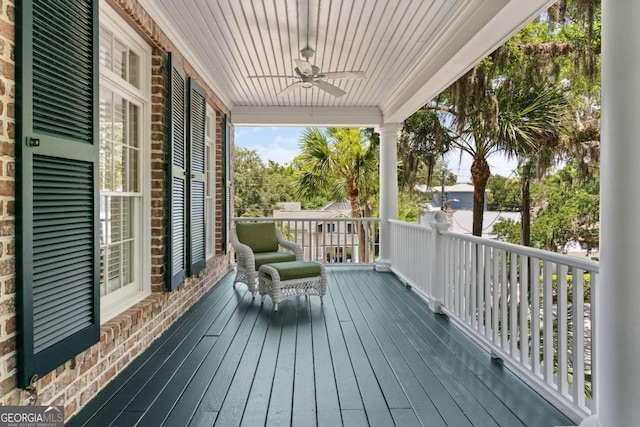 wooden terrace featuring ceiling fan and a porch