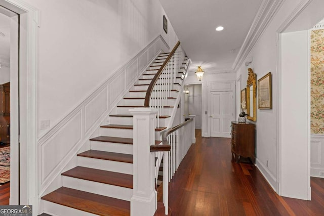 stairs featuring hardwood / wood-style flooring and crown molding