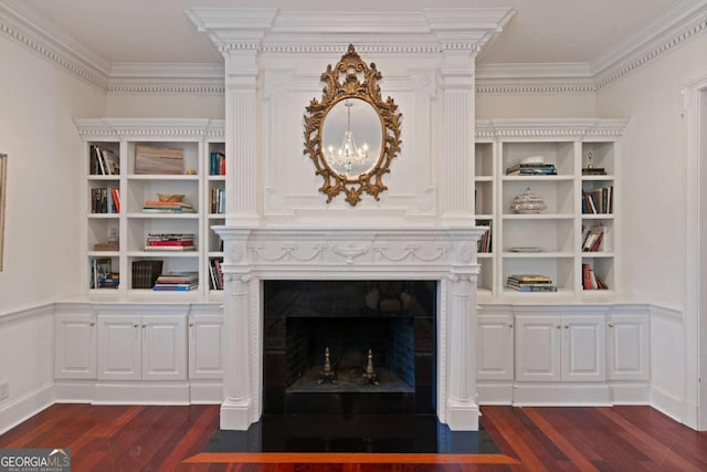 unfurnished living room with built in features, dark hardwood / wood-style floors, and ornamental molding