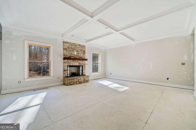 unfurnished living room with beamed ceiling, a stone fireplace, crown molding, and coffered ceiling