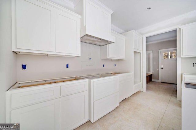 kitchen featuring white cabinets and premium range hood