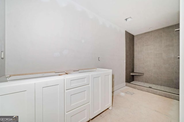 bathroom with a tile shower