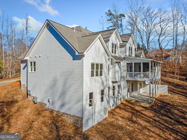 view of side of home featuring a sunroom