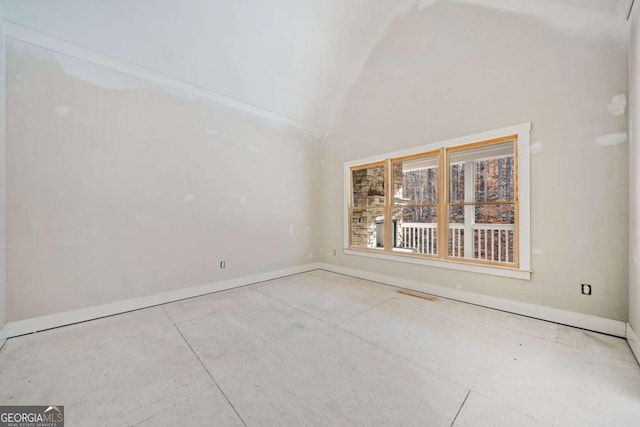 spare room with vaulted ceiling