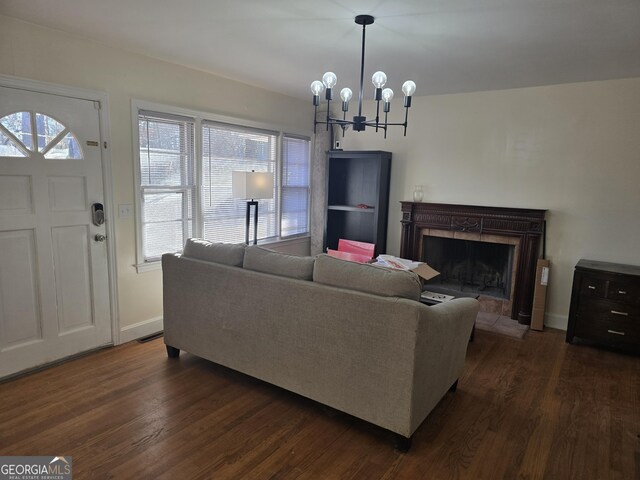 living room featuring a chandelier and dark hardwood / wood-style flooring